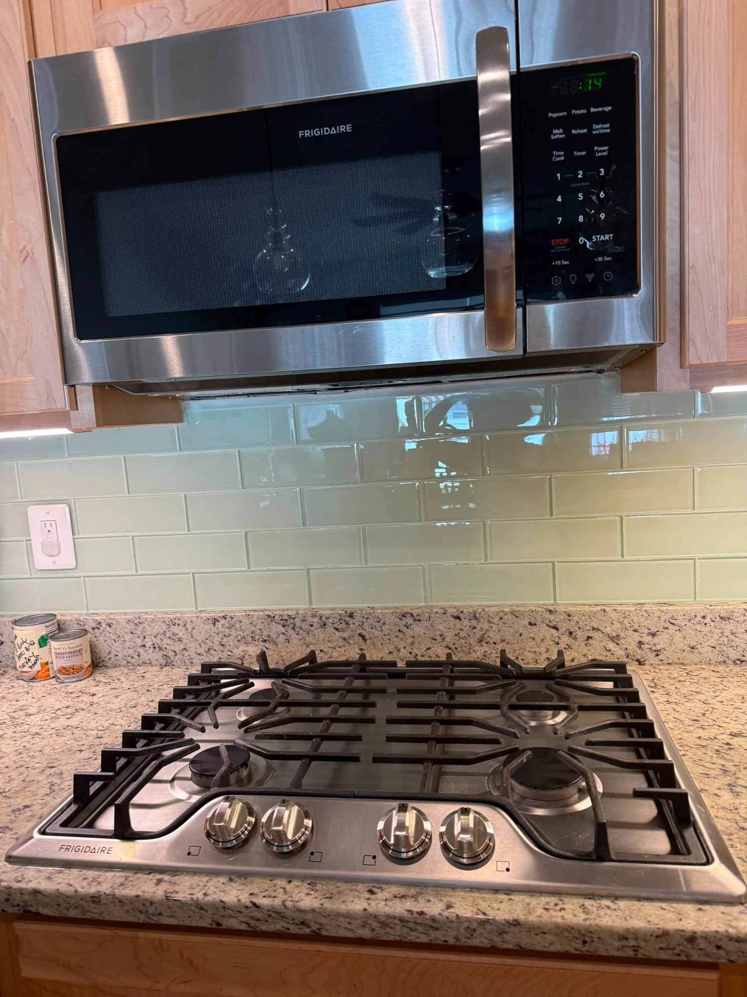 Professionally cleaned kitchen cooktop and stainless steel microwave